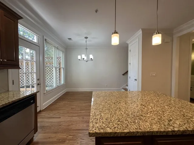 a view of a kitchen with a sink and wooden floor