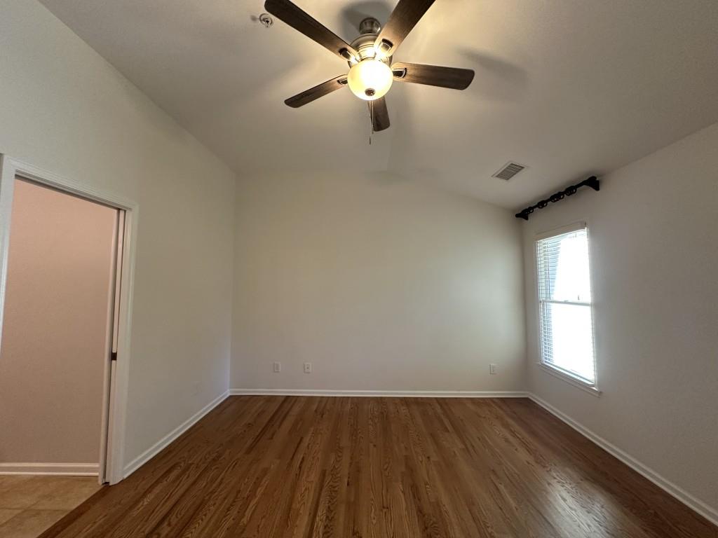 11191 Calypso Drive Alpharetta, GA 30009 - Photo 22 of 37 wooden floor in an empty room with a window