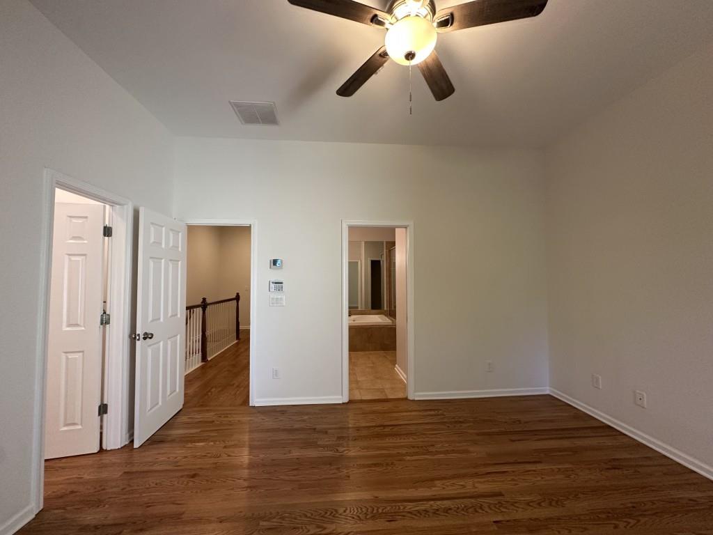 11191 Calypso Drive Alpharetta, GA 30009 - Photo 23 of 37 a view of an empty room with wooden floor