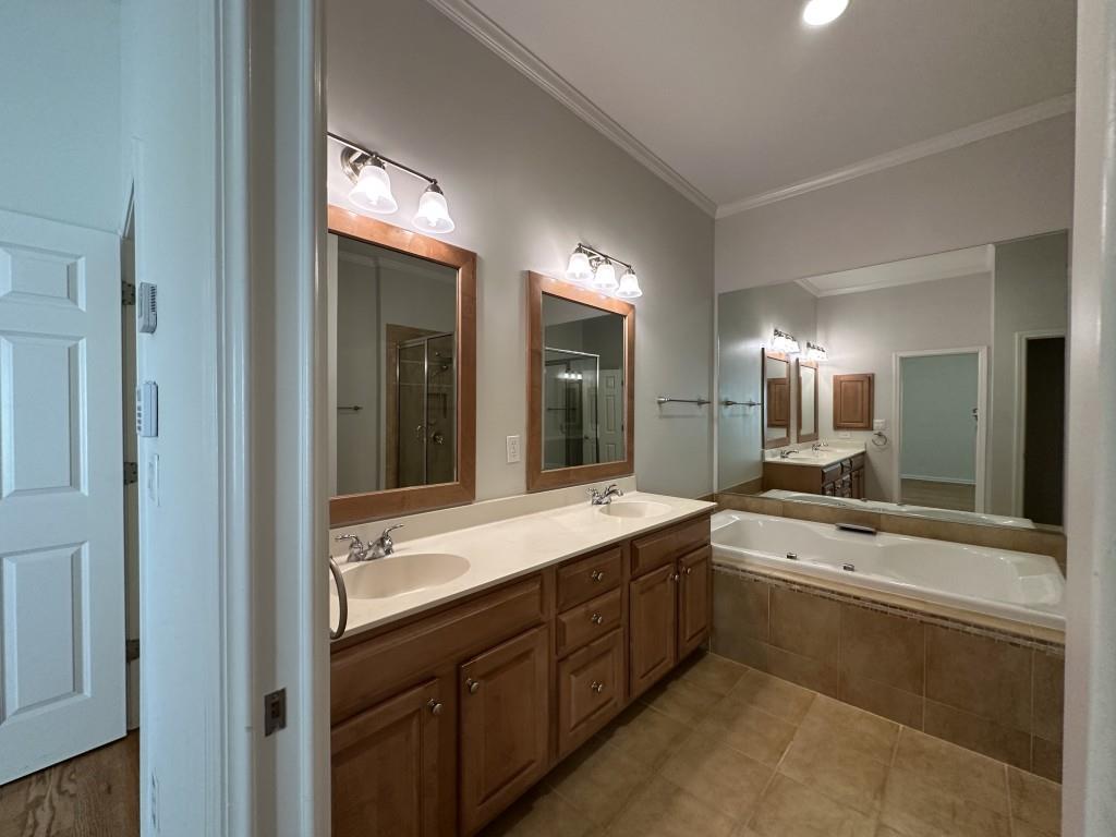 11191 Calypso Drive Alpharetta, GA 30009 - Photo 24 of 37 a bathroom with a sink double vanity and a large mirror