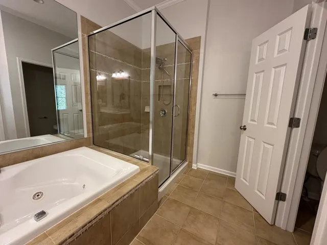 a bathroom with a tub and a shower
