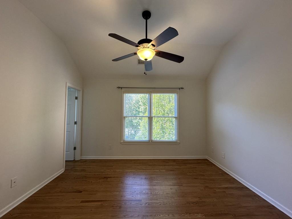 11191 Calypso Drive Alpharetta, GA 30009 - Photo 32 of 37 a view of a room with wooden floor a ceiling fan and windows