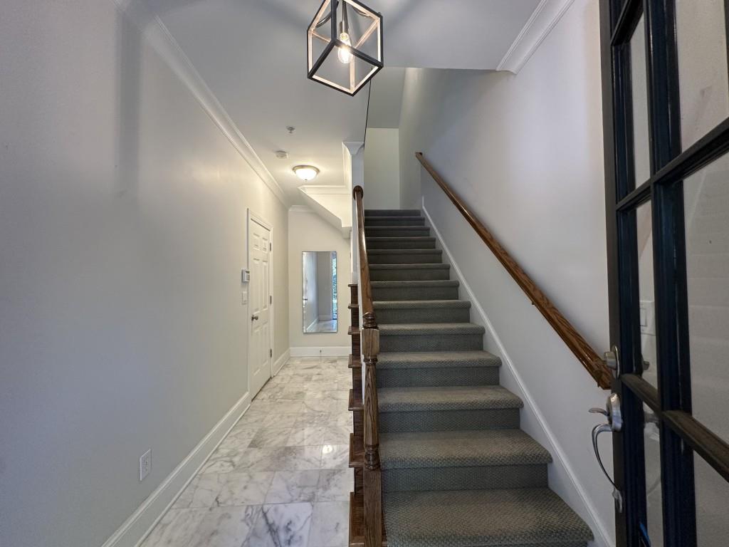 11191 Calypso Drive Alpharetta, GA 30009 - Photo 4 of 37 a view of staircase with lots of frames and wooden floor