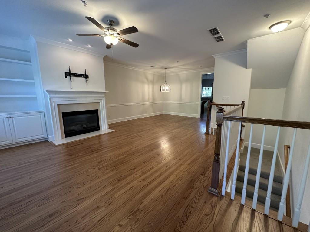 11191 Calypso Drive Alpharetta, GA 30009 - Photo 7 of 37 wooden floor in an empty room with a fireplace
