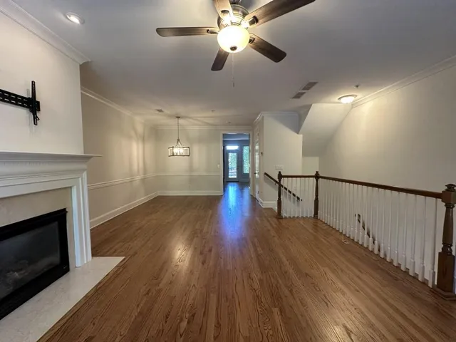 a view of empty room with wooden floor and fireplace