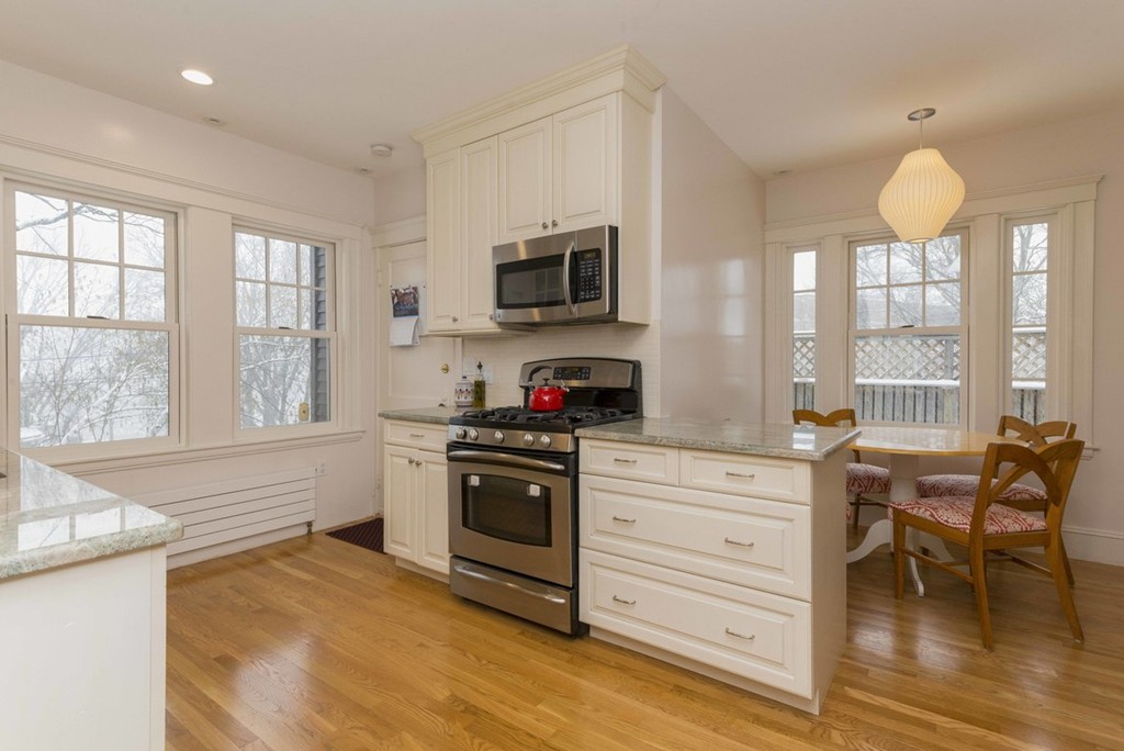 a kitchen with a stove a sink and a microwave
