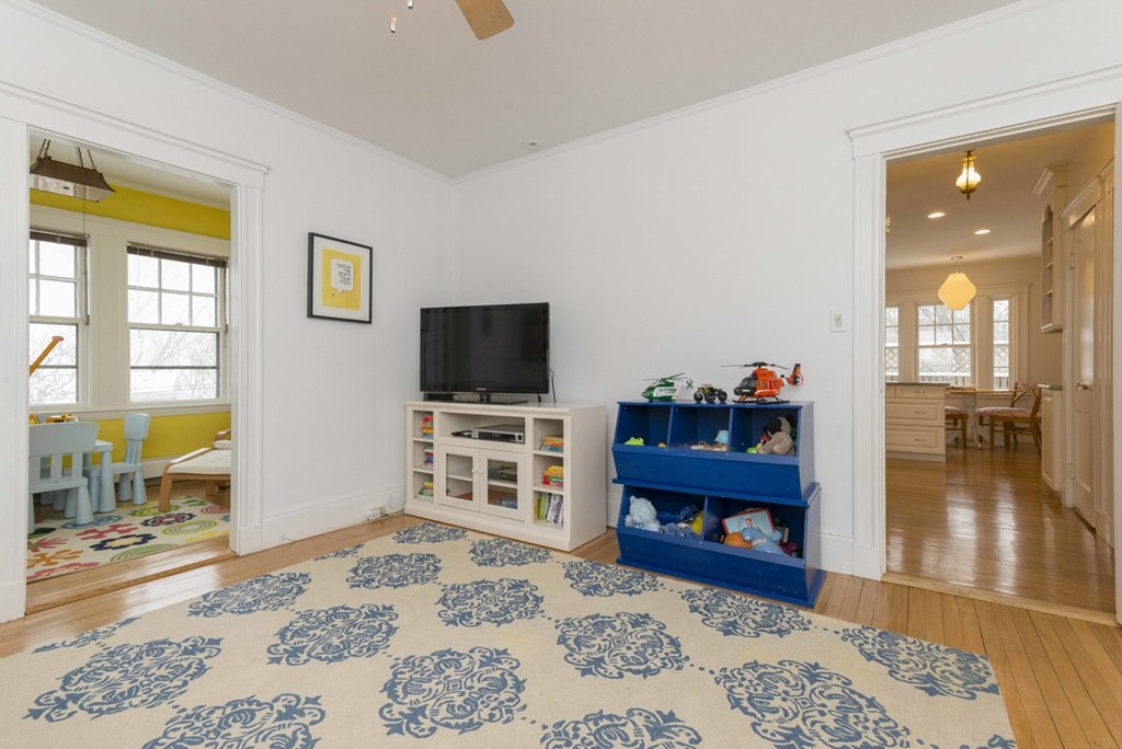 3 Addington Road, Unit 2 Brookline, MA 02445 - Photo 7 of 27 a view of a bedroom with wooden floor and a flat screen tv