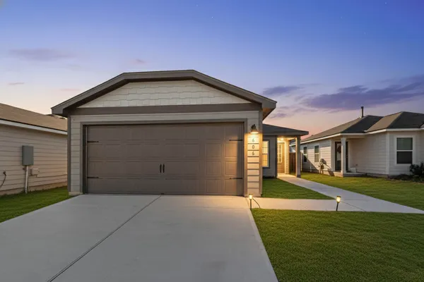 a front view of a house with a yard