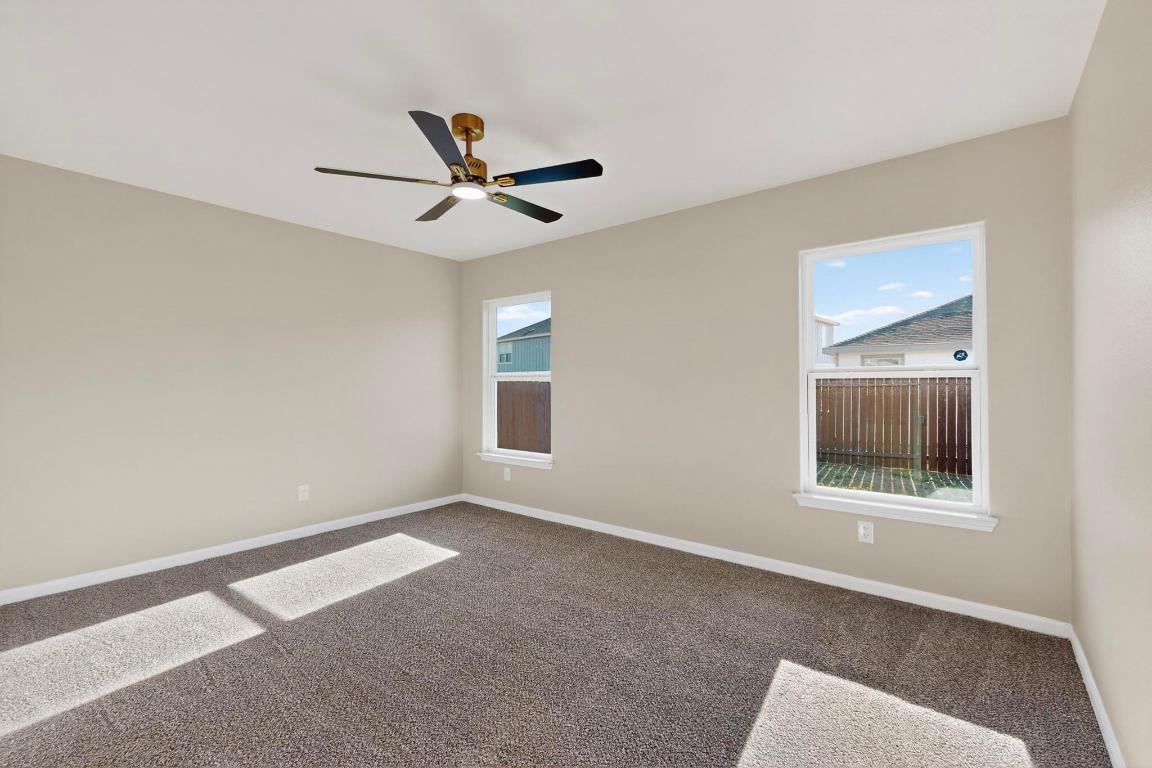 606 Aplite Pass Maxwell, TX 78656 - Photo 15 of 30 Empty room with carpet flooring, plenty of natural light, and ceiling fan