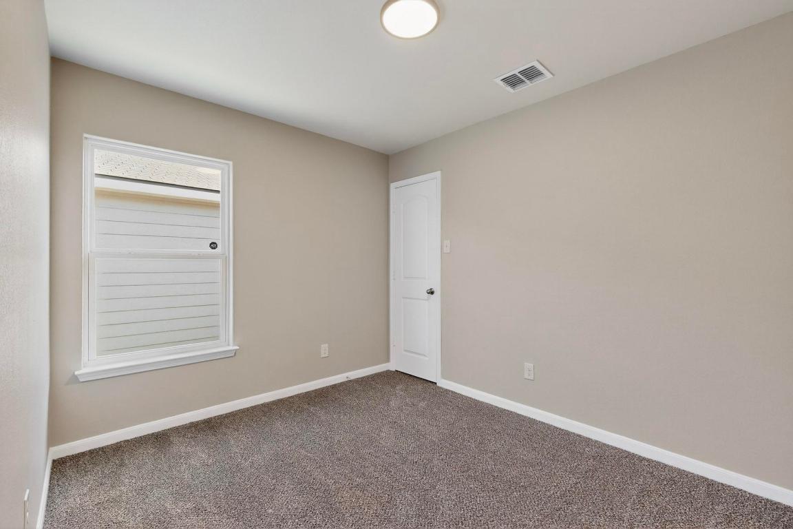 606 Aplite Pass Maxwell, TX 78656 - Photo 20 of 30 Carpeted spare room featuring baseboards