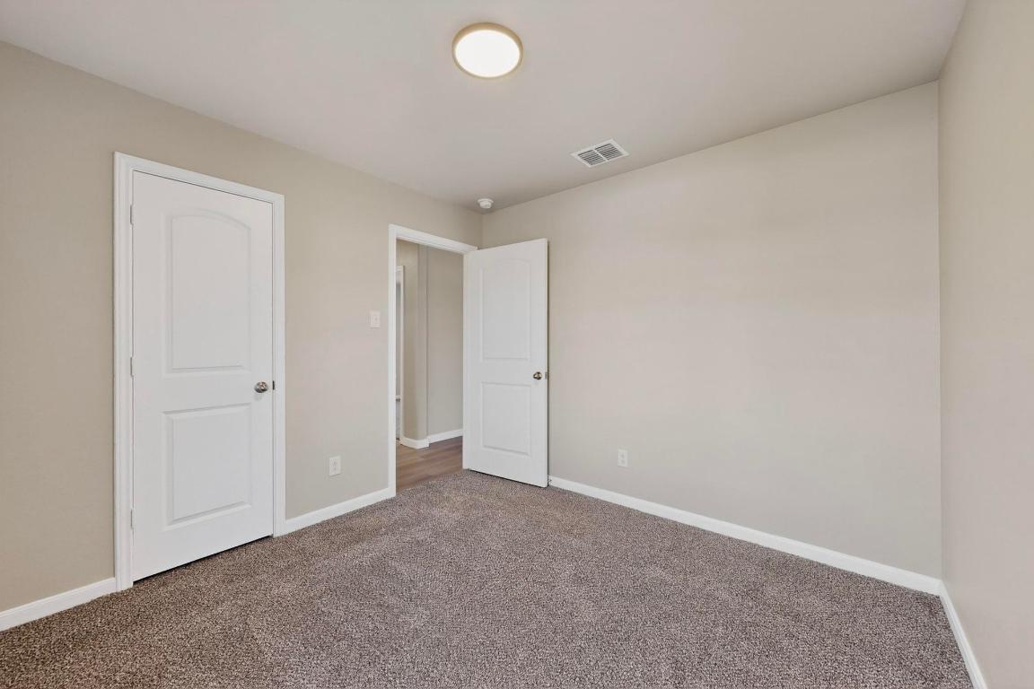 606 Aplite Pass Maxwell, TX 78656 - Photo 22 of 30 Unfurnished bedroom with carpet floors and baseboards