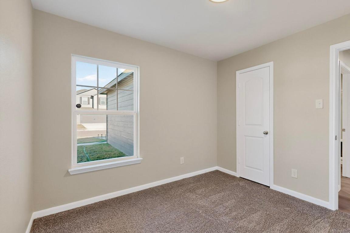 606 Aplite Pass Maxwell, TX 78656 - Photo 23 of 30 Carpeted empty room featuring baseboards