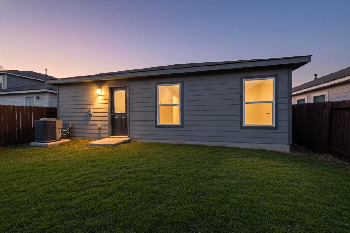 606 Aplite Pass Maxwell, TX 78656 - Photo 29 of 30 Back of property at dusk with a fenced backyard