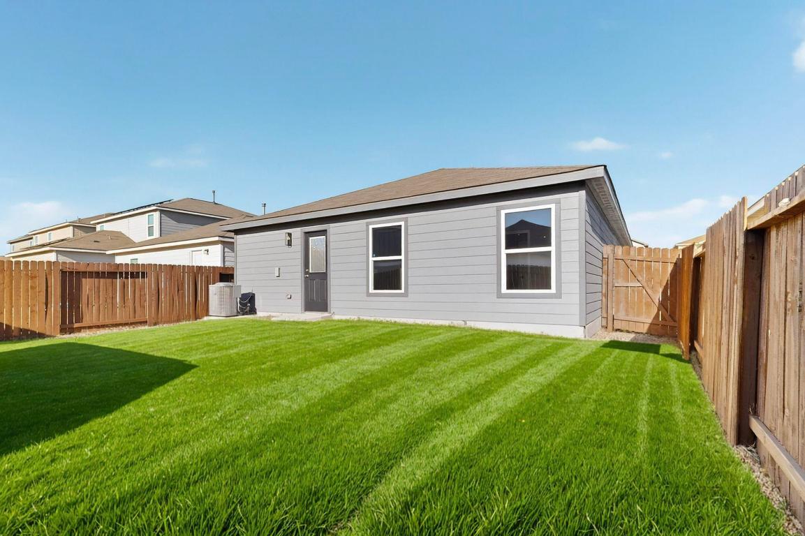 606 Aplite Pass Maxwell, TX 78656 - Photo 30 of 30 Rear view of house with a fenced backyard