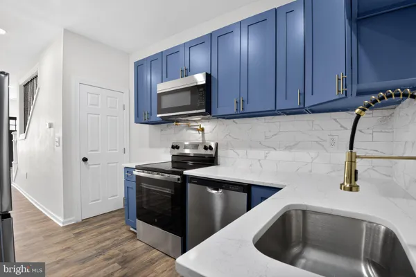 a kitchen with a sink stove and cabinets