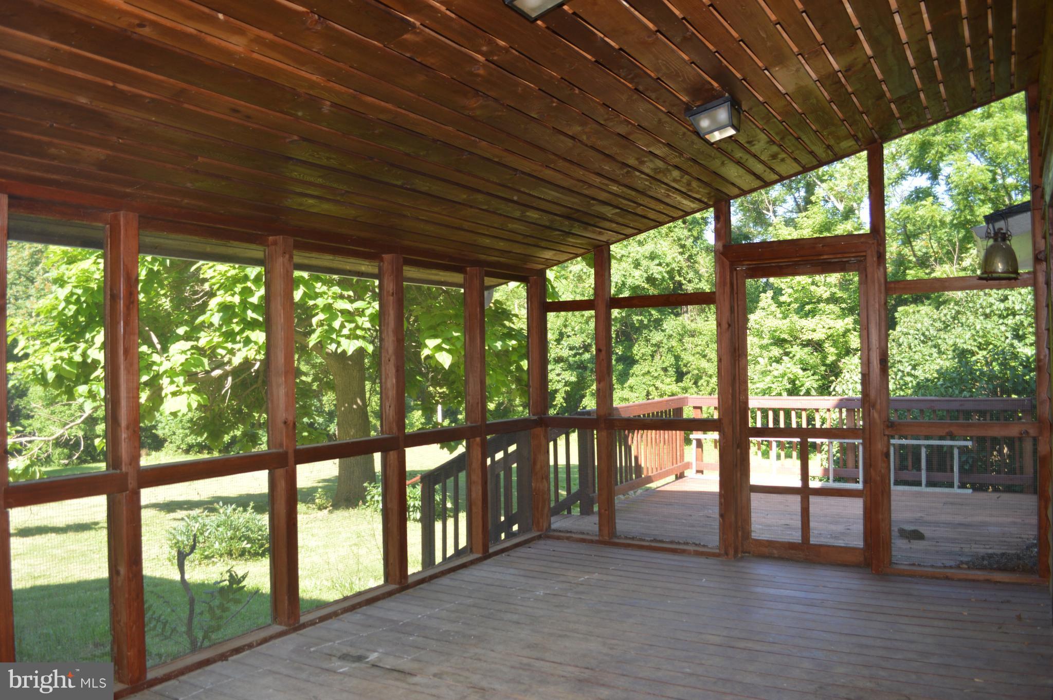 2034 Smith Run Road Bentonville, VA 22610 - Photo 29 of 30 Screened in porch leading out to the deck