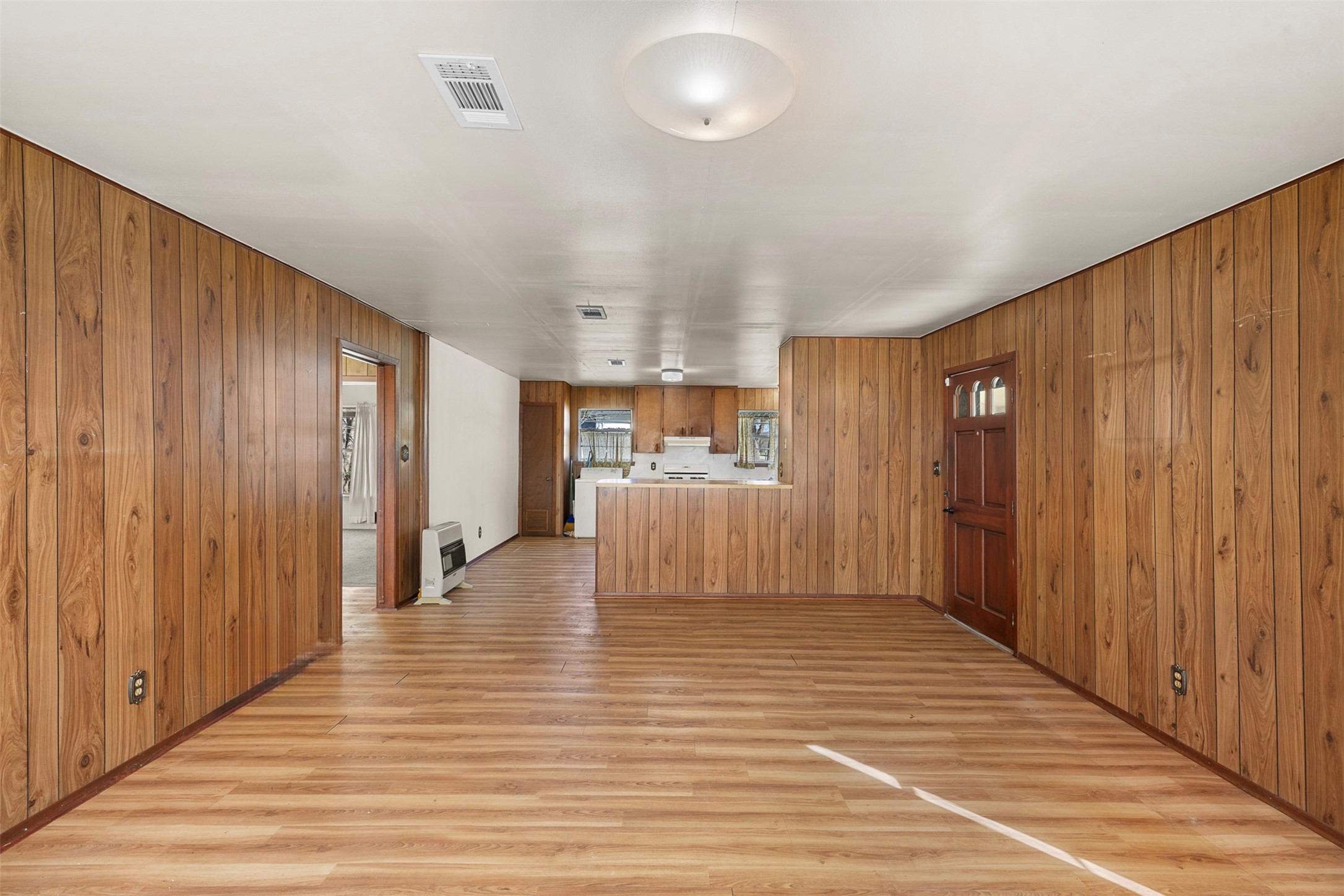 809 Main Street Lexington, TX 78947 - Photo 8 of 23 an empty room with wooden floor and windows