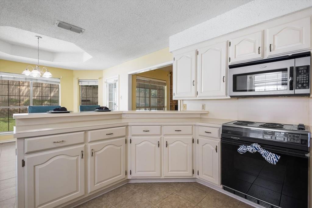 2824 Crestview Avenue Tyler, TX 75701 - Photo 14 of 39 a kitchen with white cabinets and white appliances