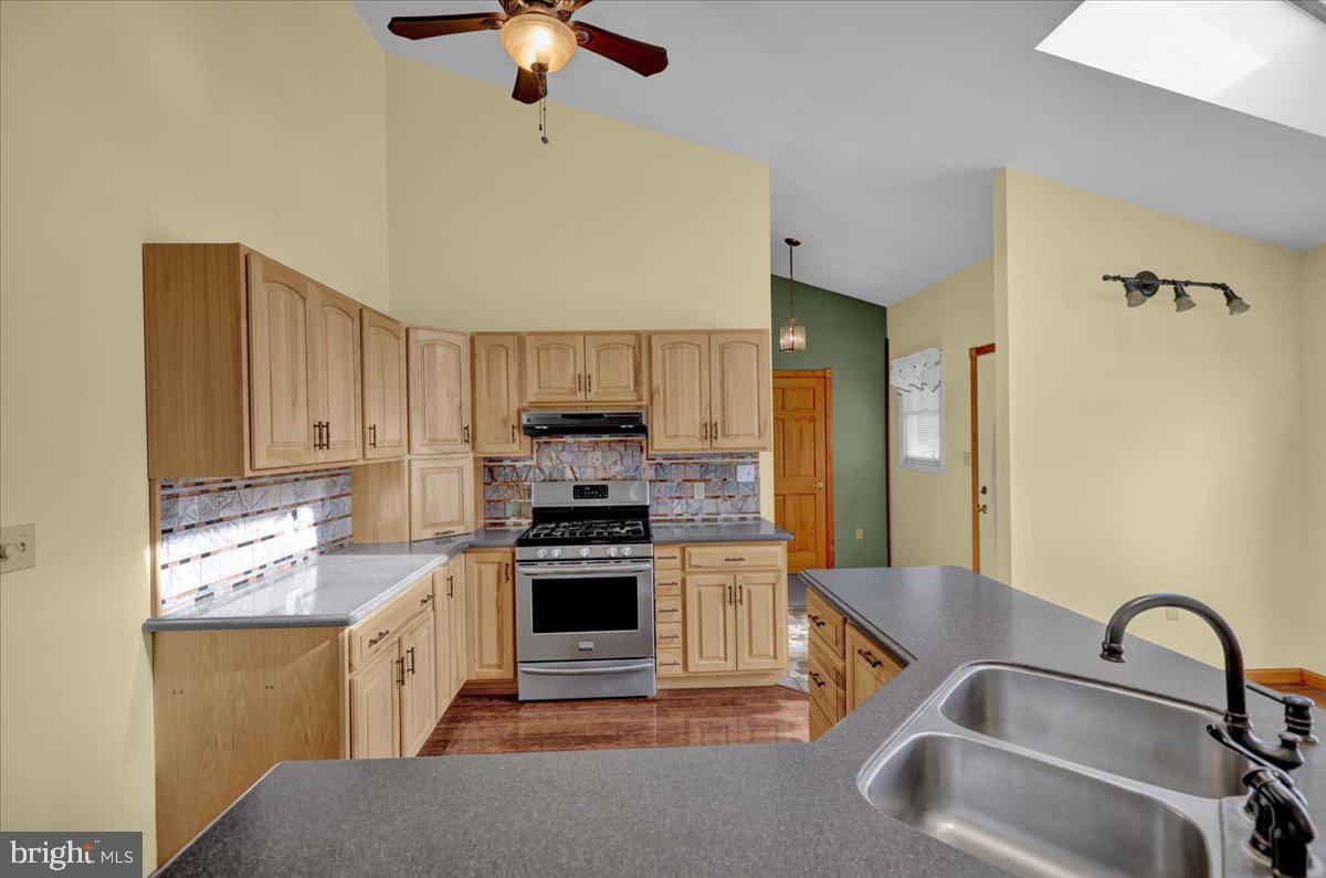 4496 Pheasant Run Reading, PA 19606 - Photo 5 of 37 a kitchen with stainless steel appliances granite countertop a sink stove and refrigerator