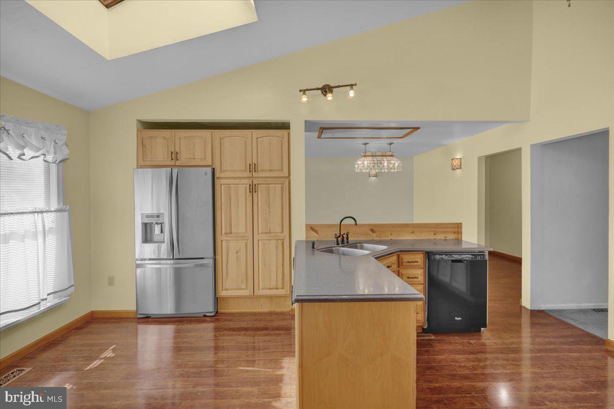 4496 Pheasant Run Reading, PA 19606 - Photo 7 of 37 a kitchen with stainless steel appliances granite countertop a refrigerator a stove and a sink with wooden floor