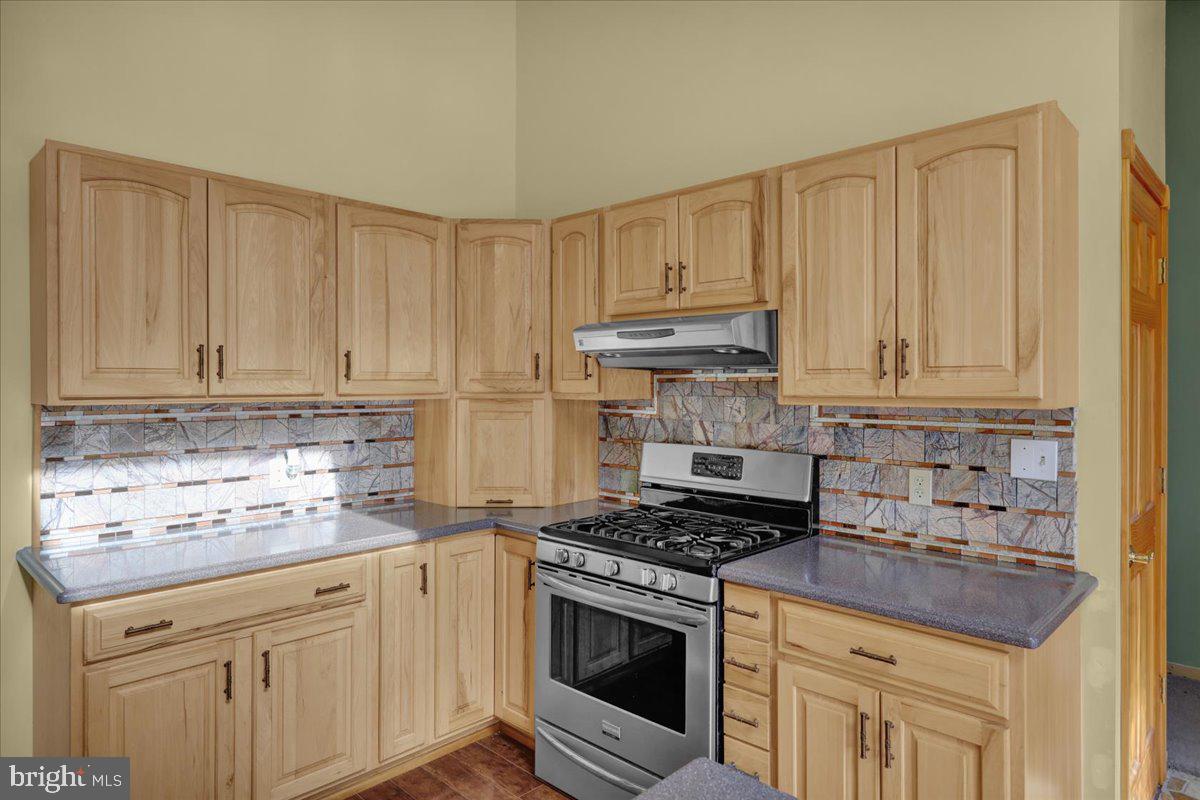 4496 Pheasant Run Reading, PA 19606 - Photo 9 of 37 a kitchen with granite countertop white cabinets and stainless steel appliances