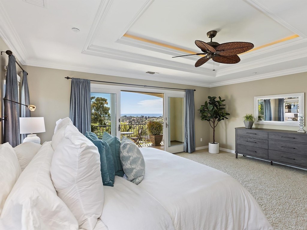 602 West Bluff Court Encinitas, CA 92024 - Photo 36 of 69 a bedroom with a large bed and a chandelier