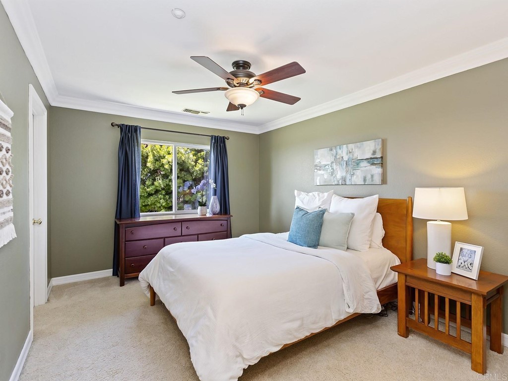 602 West Bluff Court Encinitas, CA 92024 - Photo 45 of 69 a bedroom with a large bed and a chandelier