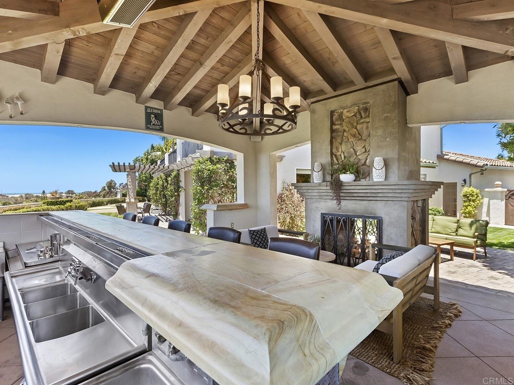 602 West Bluff Court Encinitas, CA 92024 - Photo 56 of 69 a view of a dining room with furniture a chandelier and wooden floor