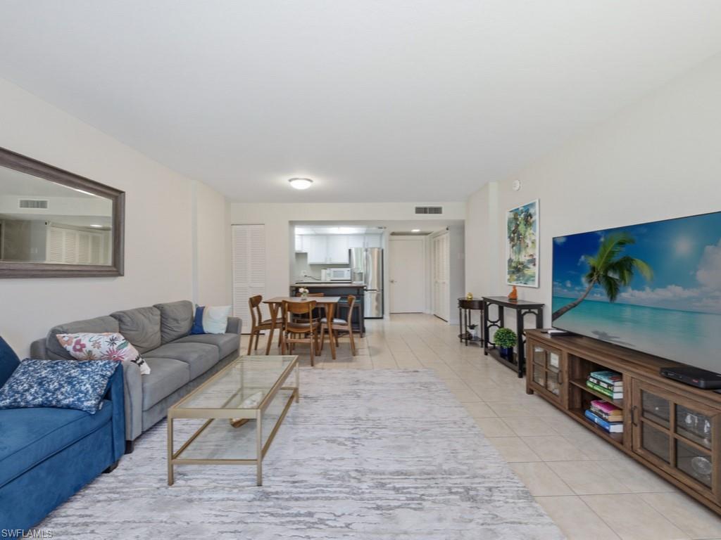 3 Bluebill Avenue, Unit 206 Naples, FL 34108 - Photo 4 of 19 a living room with furniture and a flat screen tv