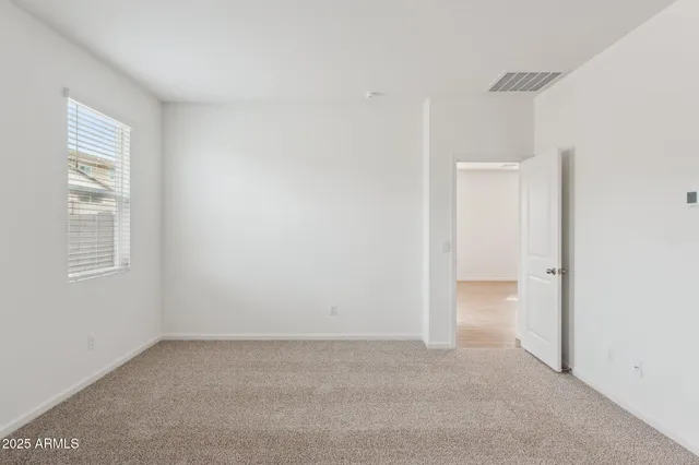 a view of an empty room and a window