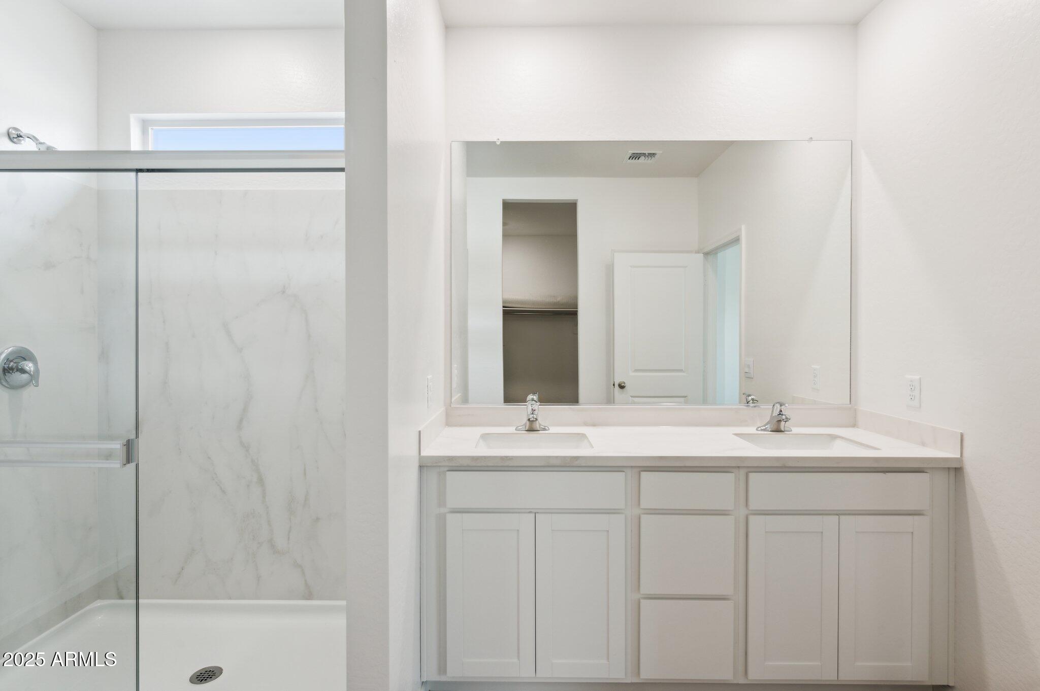 25464 West Fraktur Road Buckeye, AZ 85326 - Photo 8 of 19 a bathroom with a sink and a mirror