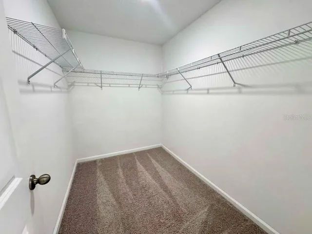 a spacious bathroom with a granite countertop sink toilet mirror and a bathtub