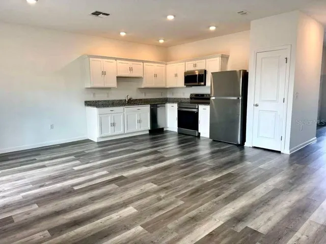 a kitchen with stainless steel appliances refrigerator sink and microwave