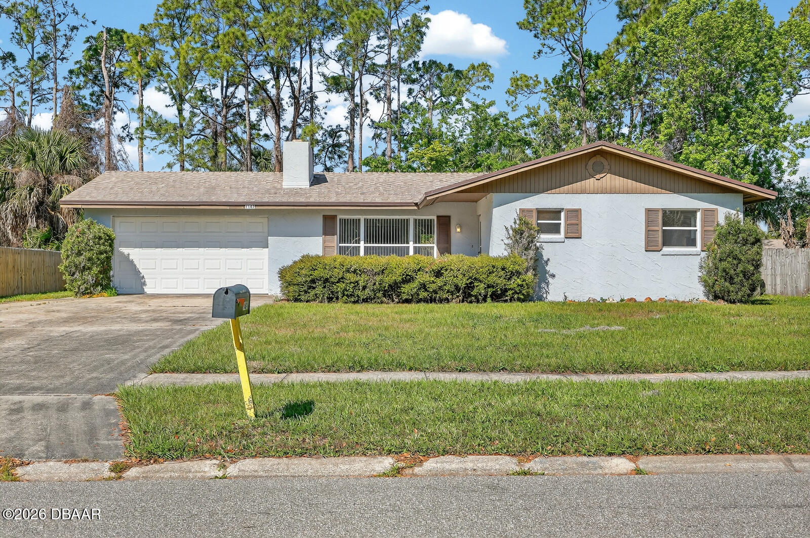 1147 Harms Way Port Orange, FL 32129 - Photo 1 of 38 a front view of a house with garage and garden