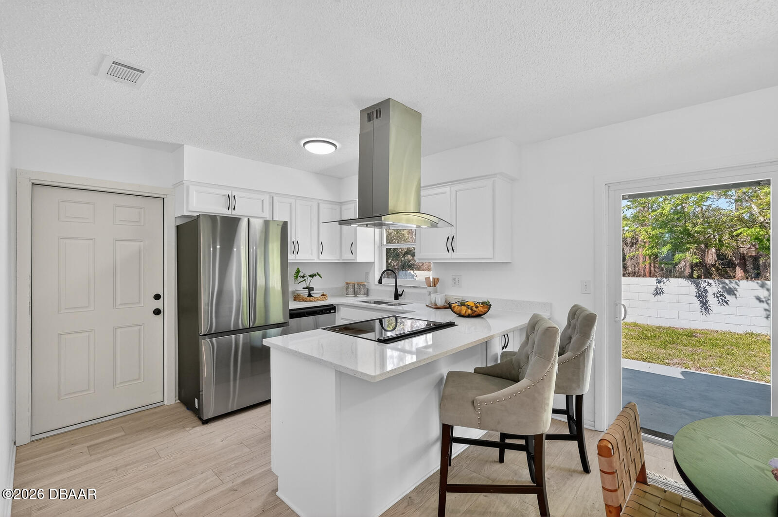 1147 Harms Way Port Orange, FL 32129 - Photo 14 of 38 a kitchen with stainless steel appliances granite countertop a dining table chairs refrigerator and sink