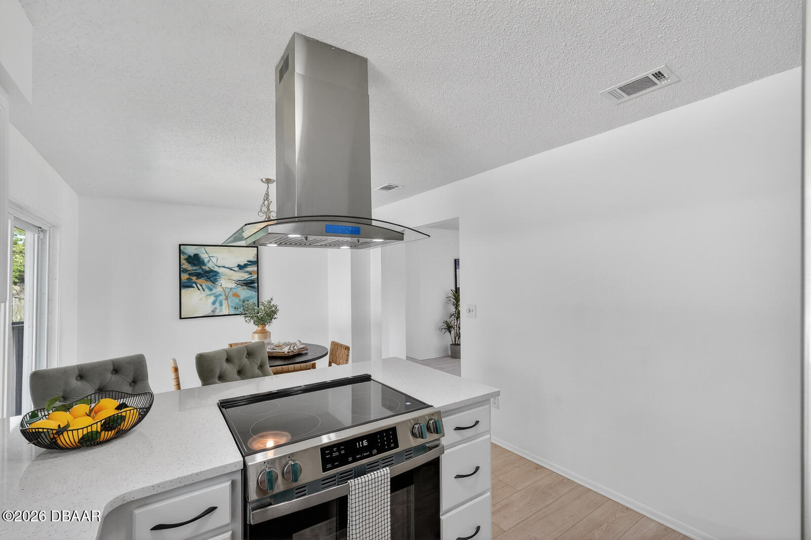 1147 Harms Way Port Orange, FL 32129 - Photo 17 of 38 a room with stainless steel appliances kitchen island a stove and white cabinets