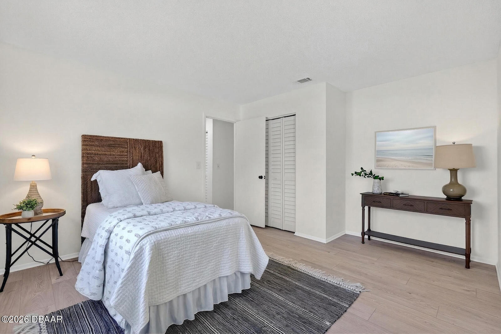 1147 Harms Way Port Orange, FL 32129 - Photo 29 of 38 a spacious bedroom with a bed and a lamp