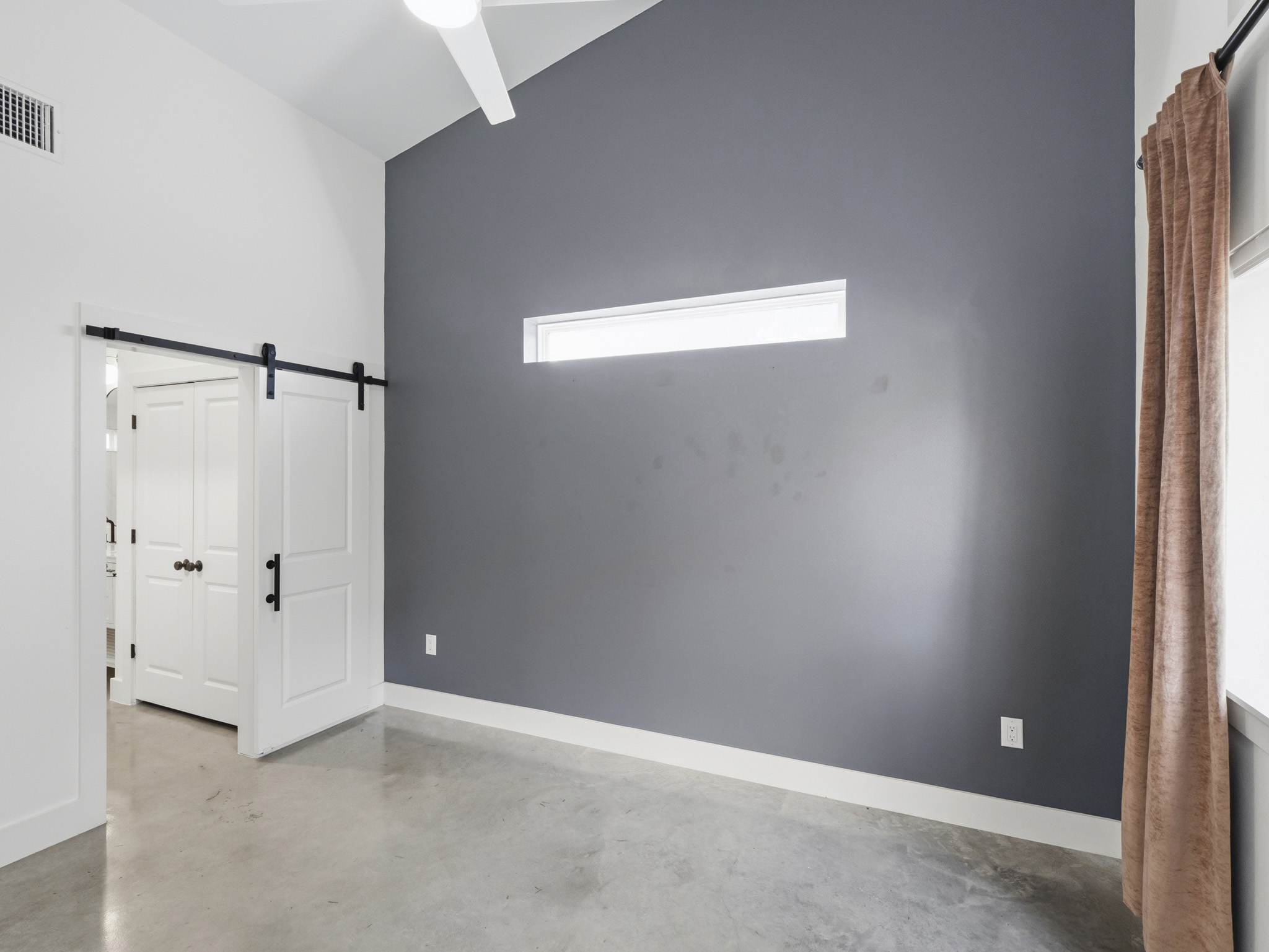 5005 Lott Avenue, Unit 2 Austin, TX 78721 - Photo 11 of 25 Concrete floors and high vaulted ceilings define this contemporary living space.