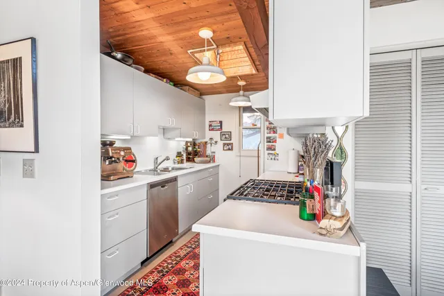 a kitchen with a refrigerator and a stove