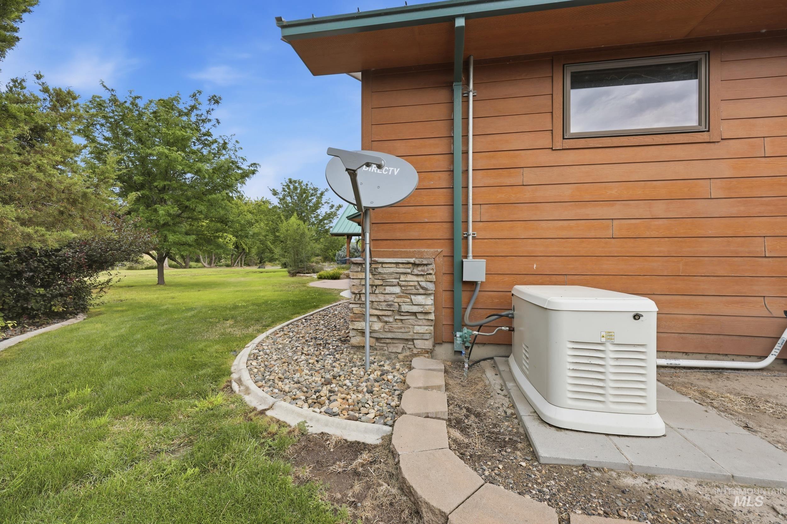339 Airport Road Weiser, ID 83672 - Photo 35 of 49 Wood-sided exterior featuring a window, built-in generator, and satellite dish