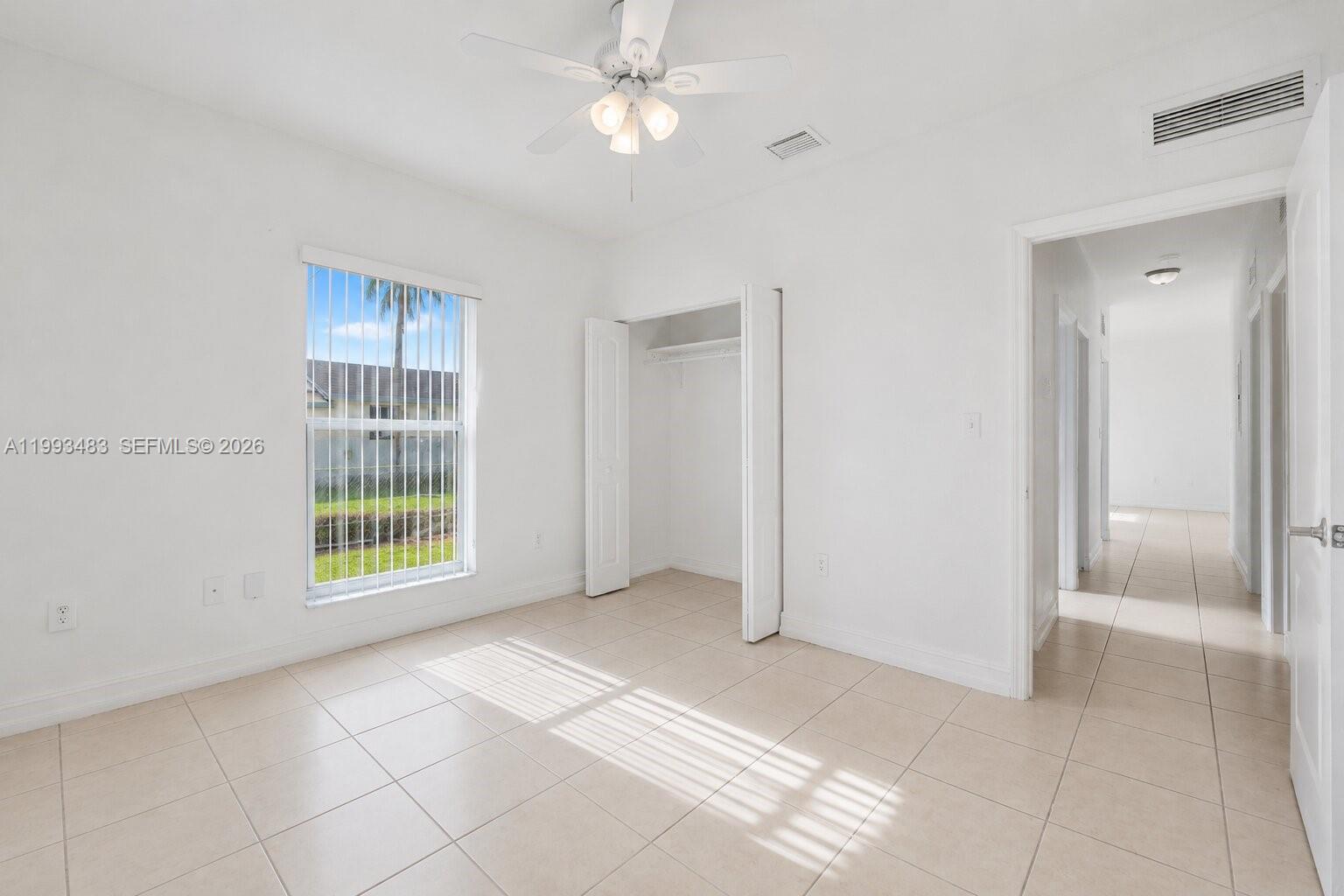 10357 Southwest 178th Street, Unit 10357 Miami, FL 33157 - Photo 24 of 25 a view of an empty room with a window