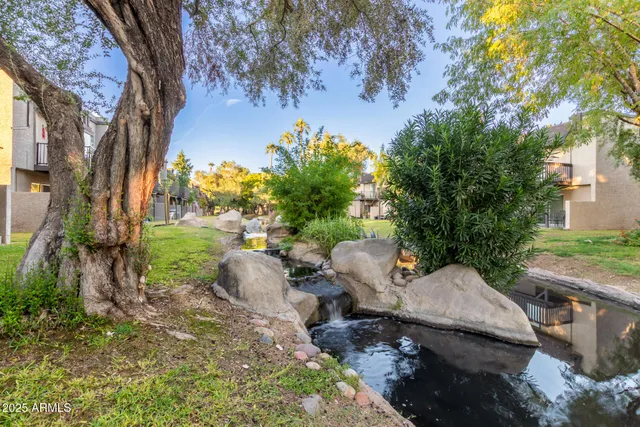 a backyard of a house with table and chairs
