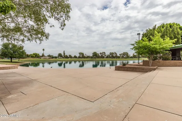 a view of a swimming pool and trees in the background