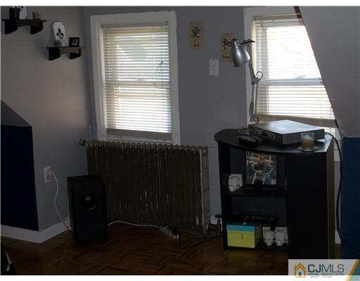 176 Rector Street Perth Amboy, NJ 08861 - Photo 17 of 24 a bathroom with a sink a mirror and window