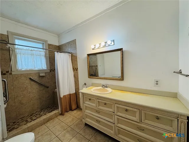 a bathroom with a sink a mirror and a shower