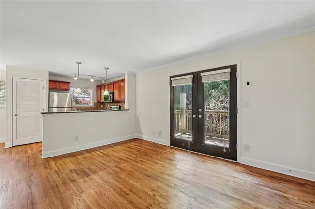 a view of a room with wooden floor and window