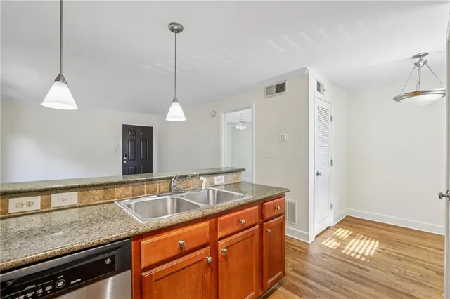 a kitchen with a sink and chandelier