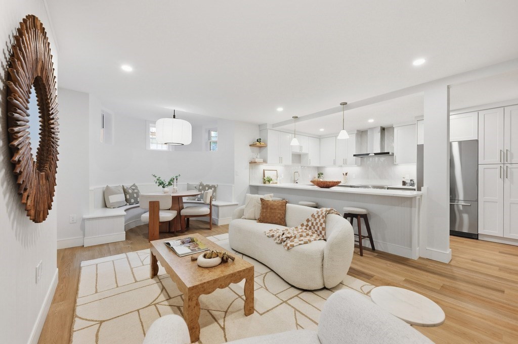 a living room with furniture and a wooden floor