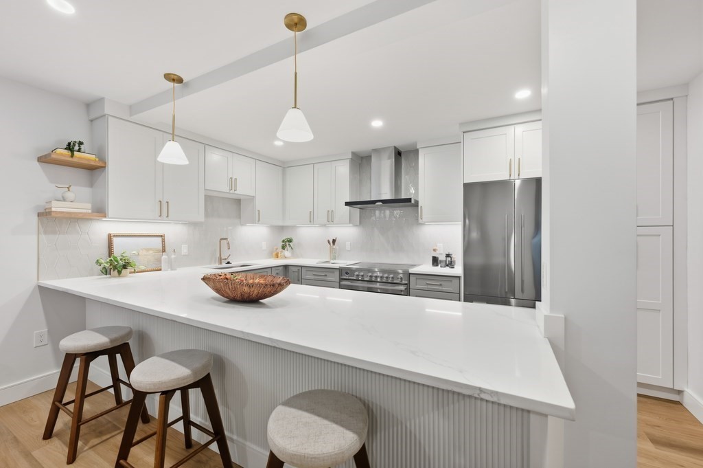 94 St Botolph Street, Unit 1 Boston, MA 02116 - Photo 11 of 37 a kitchen with a sink a refrigerator and chairs