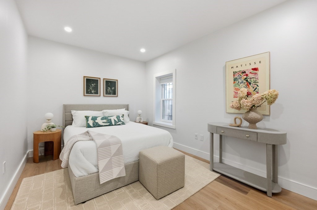 94 St Botolph Street, Unit 1 Boston, MA 02116 - Photo 19 of 37 a bedroom with a large bed and a chandelier